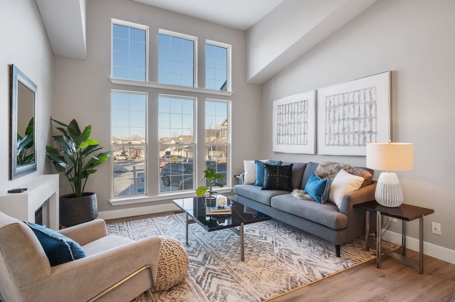 Modern living room renovation Calgary — fireplace and windows