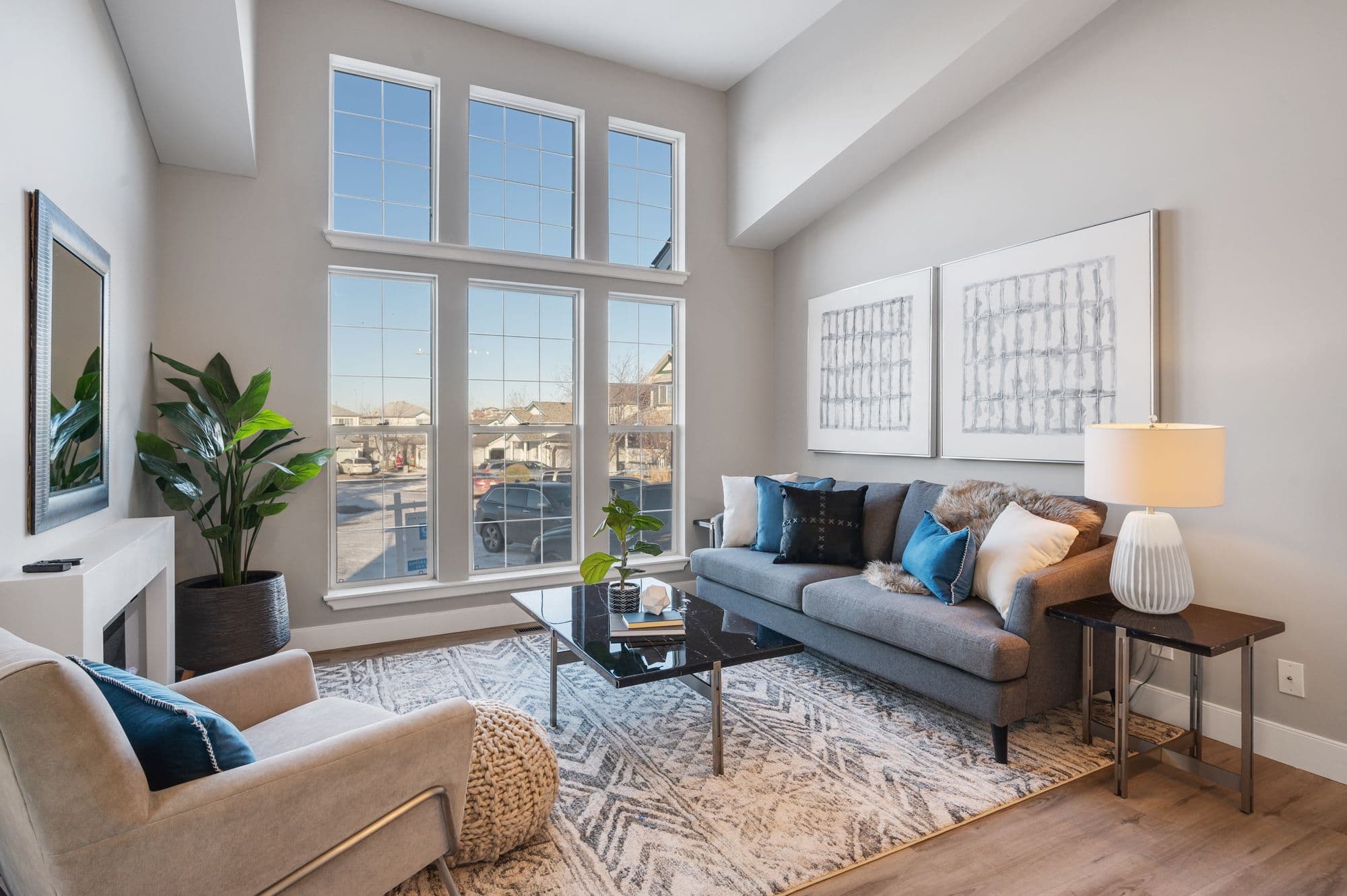 Modern living room renovation Calgary — fireplace and windows