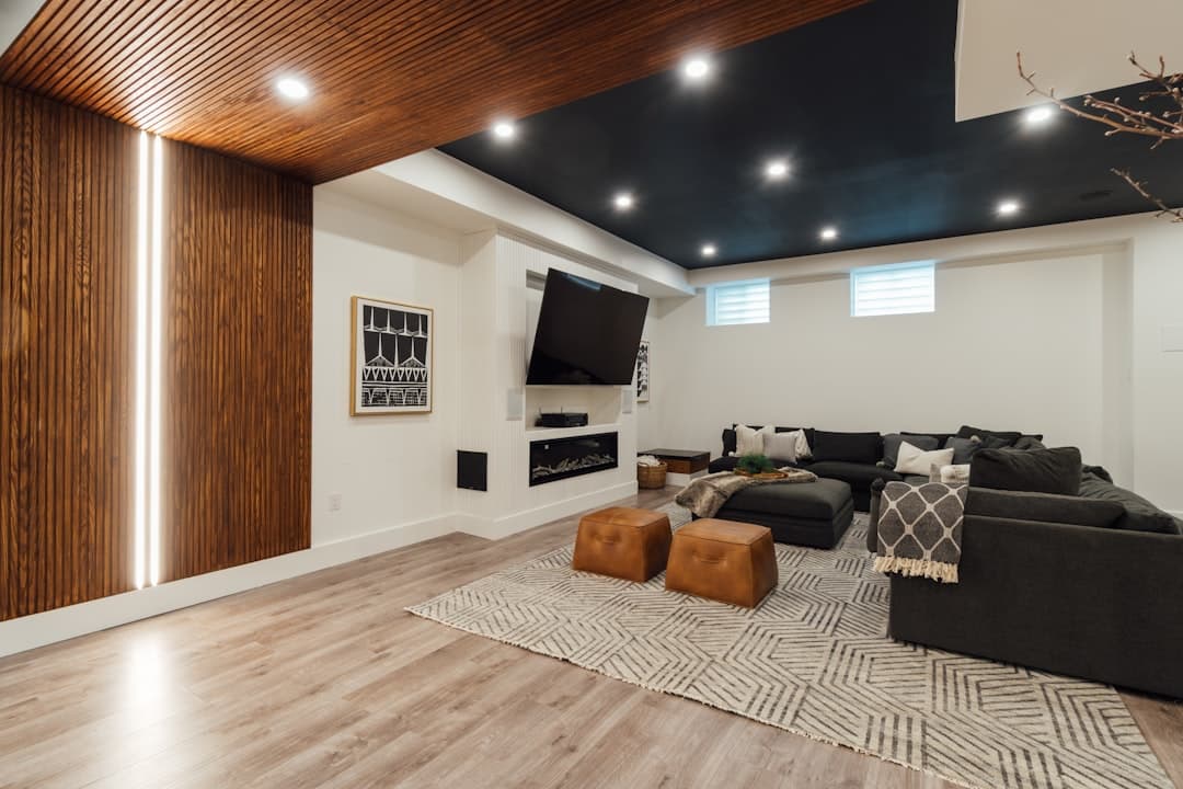 Finished Calgary basement living space with open-concept layout, pot lighting, and modern finishes.